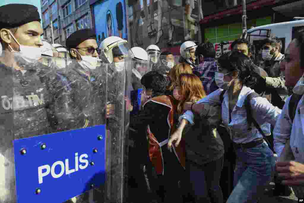 Turkish police officers in riot gear and face masks come up against protesters during a demonstration in Istanbul, Tuesday, June 2, 2020, against the recent killing of George Floyd by police officers in Minneapolis, USA. (AP Photo/Omer Kuscu)