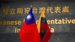 FILE - Taiwanese and Lithuanian flags are displayed at the Taiwanese Representative Office in Vilnius, Lithuania, Jan. 20, 2022.