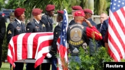 FILE - An honor guard carries the coffin of U.S. Army Sergeant La David Johnson, who was among four special forces soldiers killed in Niger, at a graveside service in Hollywood, Florida, Oct. 21, 2017. 