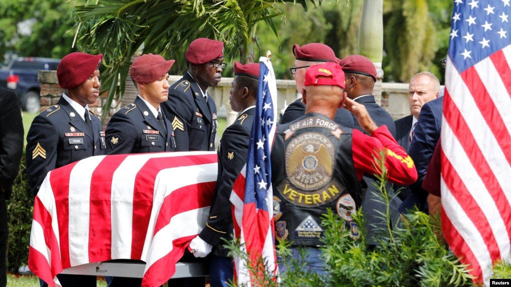 FILE - An honor guard carries the coffin of U.S. Army Sergeant La David Johnson, who was among four special forces soldiers killed in Niger, at a graveside service in Hollywood, Florida, Oct. 21, 2017.