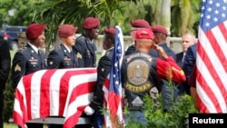 FILE - An honor guard carries the coffin of U.S. Army Sergeant La David Johnson, who was among four special forces soldiers killed in Niger, at a graveside service in Hollywood, Florida, Oct. 21, 2017. 