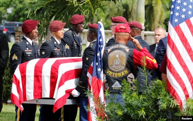 FILE - An honor guard carries the coffin of U.S. Army Sergeant La David Johnson, who was among four Special Forces soldiers killed in Niger, at a graveside service in Hollywood, Fla., Oct. 21, 2017.