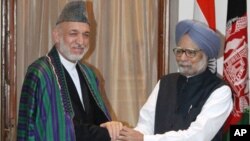 Afghan President Hamid Karzai with Indian Prime Minister Manmohan Singh, Oct. 4, 2011.