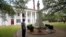 In this Aug. 1, 2018 photo, Ronnie Anderson, an African-American man charged with possession of a firearm by a convicted felon, waits next to a confederate statue on the lawn of the East Feliciana Parish Courthouse in Clinton, La.