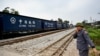 A railway worker guides a train in Hanoi, Vietnam, on Feb. 13, 2025. Vietnam's National Assembly on Feb. 19 approved the use of Chinese loans to build an $8 billion rail link from its largest northern port city to the border with China.