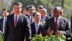 China's President Xi Jinping, left, walks with South African President Cyril Ramaphosa after a joint press conference at the government's Union Buildings in Pretoria, South Africa, July 24, 2018. Xi is in the country to attend a three-day BRICS summit starting Wednesday in Johannesburg.