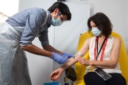 In this undated photo from the University of Oxford, a volunteer received a coronavirus vaccine developed by AstraZeneca and Oxford University, in Oxford, England. (University of Oxford/John Cairns)