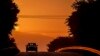 A car drives along a road as the sun rises in Frankfurt, Germany.