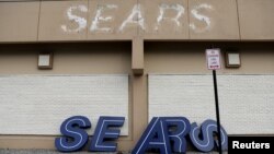 FILE - A dismantled sign sits leaning outside a Sears department store one day after it closed as part of multiple store closures by Sears Holdings Corp in the United States in Nanuet, New York, U.S., Jan/ 7, 2019. 