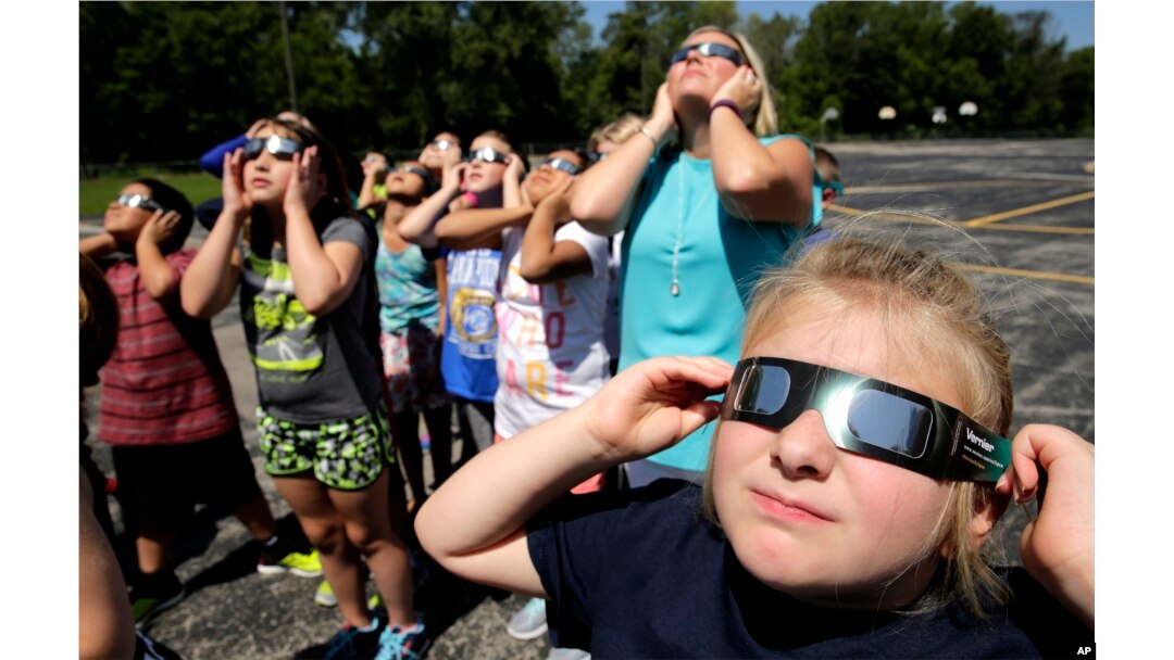 Fourth graders at Clardy Elementary School in Kansas City, Missouri, practice the proper use of their eclipse glasses in anticipation of Monday's solar eclipse, Aug. 18, 2017.