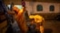 Ambulance workers take turns spraying each other with disinfectant after delivering a patient to the COVID-19 unit at Social Security hospital in Guatemala City, June 12, 2020.