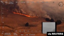 An aerial view of a bushfire in Ellerslie, New South Wales, Australia December 30, 2019 in this still image obtained from social media video. NSW RURAL FIRE SERVICE/via REUTERS THIS IMAGE HAS BEEN SUPPLIED BY A THIRD PARTY. MANDATORY CREDIT. NO…