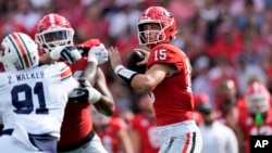 Georgia quarterback Carson Beck (15) throws from the pocket in the first half of an NCAA college football game against Auburn, Oct. 5, 2024, in Athens, Georgia.