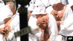 Christian penitents known locally as "Battenti" beas themselves during a procession in honor of the Virgin Mary in Guardia Sanframondi, near Benevento south of Italy, on August 22, 2010.
