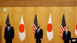 Japanese Prime Minister Yoshihide Suga, right, U.S. Secretary of State Antony Blinken, center, and U.S. Defense Secretary Lloyd Austin, left, pose for photo session during a courtesy call at the prime minister's official residence Tuesday, March 16. 2021