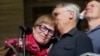 FILE - Lee Carter, whose mother, Kay, had challenged Canada's assisted-suicide ban, embraces husband Hollis Johnson while speaking to journalists in Ottawa, Feb. 6, 2015. The MAiD Act was enacted in June 2016 in response to the Carter case and others.