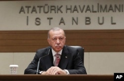 Turkey's President Recep Tayyip Erdogan talks to members of the media regarding the local elections, in Istanbul, Monday, April 8, 2019, prior to his departure for Russia.