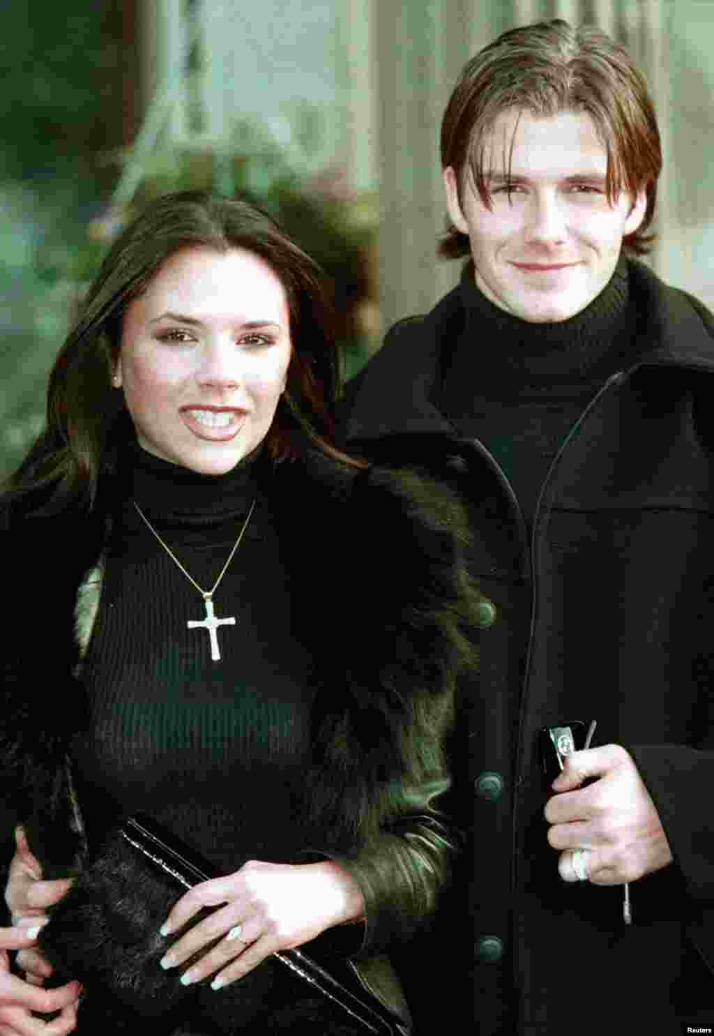 Victoria Adams poses with her then-fiancee, Manchester United footballer David Beckham, January 25, 1998. 