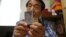 In this Aug. 17, 2018, photo, Lee Soo-nam shows photos of his brother Ri Jong Song in North Korea during an interview at his home in Seoul. Lee is among about 200 war-separated S. Korean and their family members who are crossing into N. Korea for heart-wrenching meetings with relatives they haven’t seen for decades.