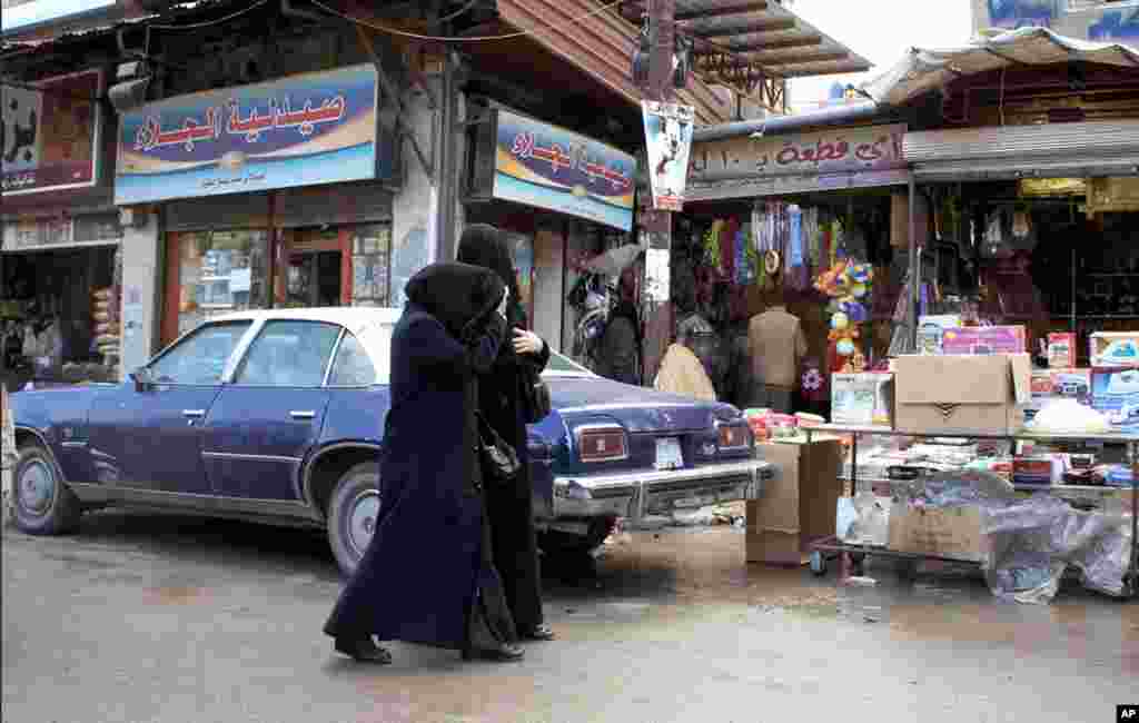 Women in Douma, where daytime is fairly calm, but nighttime brings fear. Jan. 14 2012. (E. Arrott/VOA)