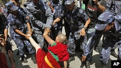 Nepalese police officers try to detain a Tibetan nun during a demonstration outside Chinese Embassy in Katmandu, Nepal. (file)