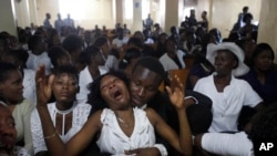 Relatives of murdered community leader Josemano "Badou" Victorieux mourn during Victorieux's funeral in Port-au-Prince, Haiti, Oct. 16, 2019. 