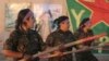 FILE - Kurdish female fighters of the Women's Protection Unit (YPJ) participate in training at a military camp in Ras al-Ain city in Syria's Hasakah province June 30, 2014.