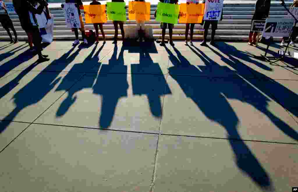 Protesters&#39; shadows are cast outside the Supreme Court.