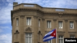 FILE - The Cuban national flag is seen raised over their embassy in Washington, July 20, 2015. 