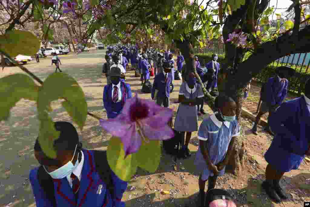Schoolchildren wait to enter their school in Harare, Zimbabwe, Monday Sept, 28, 2020. Zimbabwe schools have reopened in phases, but with smaller number of pupils, more teachers and other related measures to enable children to resume their education. (AP)