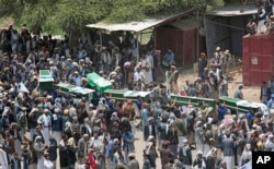 FILE - People carry coffins of victims of a Saudi-led airstrike, during a funeral in Saada, Yemen, Aug. 13, 2018.