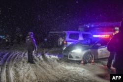 Police block the road near the site of air crash outside Moscow, Feb. 11, 2018.