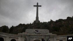 FILE - Tourists take a selfie outside of the Spanish former dictator General Francisco Franco's tomb at the Valle de los Caidos (Valley of the Fallen), near Madrid, May 10, 2016. 