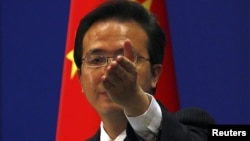 China's Foreign Ministry spokesman Hong Lei asks journalists for questions during a news conference in Beijing, July 7, 2011.