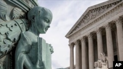 A cherub holding an open book adorns a flagpole on the plaza of the Supreme Court in Washington, Monday, April 4, 2016. The justices ruled in a case involving the constitutional principle of “one person, one vote” and unanimously upheld a Texas law that counts everyone, not just eligible voters, in deciding how to draw districts. (Associated Press)