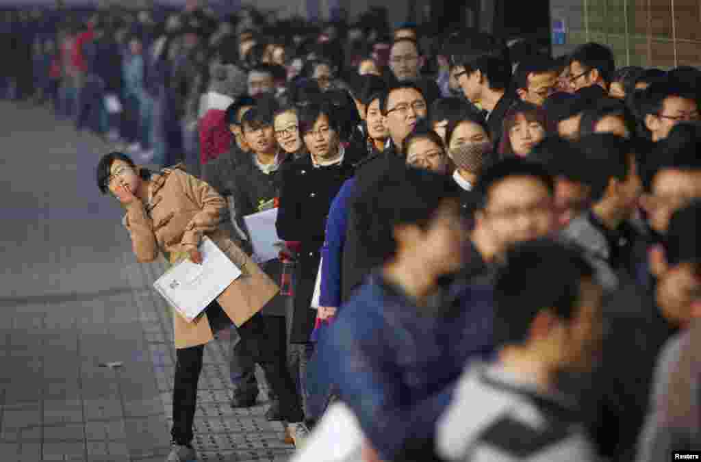 Job seekers line up at a job fair at Tianjin University in China. According to local media, more than 6,000 people rushed to the job fair on Friday for openings from 300 companies. 