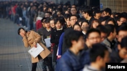 In this November 2013 file photo, job seekers line up at a job fair at Tianjin University. According to local media, more than 6,000 people rushed to the job fair for openings from 300 companies. (REUTERS)