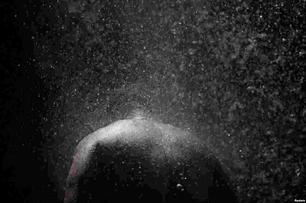 A Haitian man bathes during the celebration of the yearly pilgrimage to the waterfall in Saut D&#39;Eau, July 14, 2019.