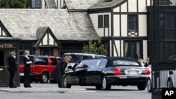 A stretch limousine arrives at Forest Lawn Cemetery for funeral services for Elizabeth Taylor in Glendale, Calif., March 24, 2011