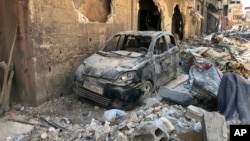 FILE - Rubble lines a street in Douma, the site of a suspected chemical weapons attack, near Damascus, Syria, April 16, 2018.