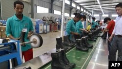 People work on the assembly line at Huajian shoe factory in Dukem, Ethiopia, April 19, 2012.