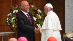 Pope Francis and Iraqi President Barham Salih shake hands, at Baghdad's Presidential Palace, Iraq, Friday, March 5, 2021. (AP Photo/Andrew Medichini)