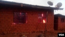 Flames are seen inside a house that allegedly was torched by the military lie in Kumbo, Cameroon. (M. Kindzeka for VOA) 
