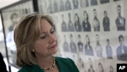 US Secretary of State Hillary Rodham Clinton looks at a wall of faces of those killed by the Khmer Rouge regime, during a tour of the Tuol Sleng Genocide Museum, formerly the regime's notorious S-21 prison, in Phnom Penh, Cambodia, 01 Nov 2010