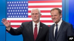 United States Vice President Mike Pence, left, waves after shaking hands with EU Council President Donald Tusk as he arrives at the European Council building in Brussels, Belgium, on Feb. 20, 2017. (AP Photo/Thierry Monasse)