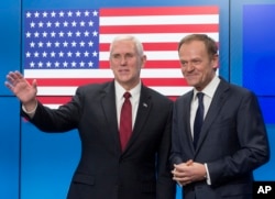 United States Vice President Mike Pence, left, gestures after shaking hands with EU Council President Donald Tusk as he arrives at the European Council building in Brussels, Belgium, on Feb. 20, 2017.