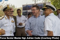 U.S. Defense Secretary Ash Carter, center right, laughs with Indian naval officers as he arrives at the Karwar naval base in India to visit the Indian aircraft carrier INS Vikramaditya, April 11, 2016.