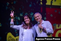 Chilean presidential candidate for the Partido Republicano party, Jose Antonio Kast (R), accompanied by his wife Maria Pia Adriasola, greets his supporters during his closing campaign rally at Araucanos Park, Santiago, Dec. 16, 2021, ahead of the presiden