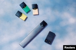 FILE - A Juul e-cigarette and pods are seen in this picture illustration, Sept. 16, 2018.