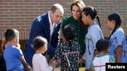 Britain's Prince William and Catherine, Duchess of Cambridge, receive gifts from aboriginal children during a ceremony at the University of British Columbia Okanagan in Kelowna, Sept. 27, 2016. 